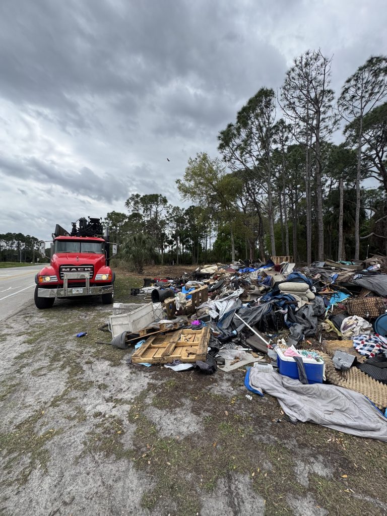 Who Is Responsible When a Neighbor's Tree Falls on Your Property in Florida? 6 Storm debris pile and haul truck after a Brevard County storm